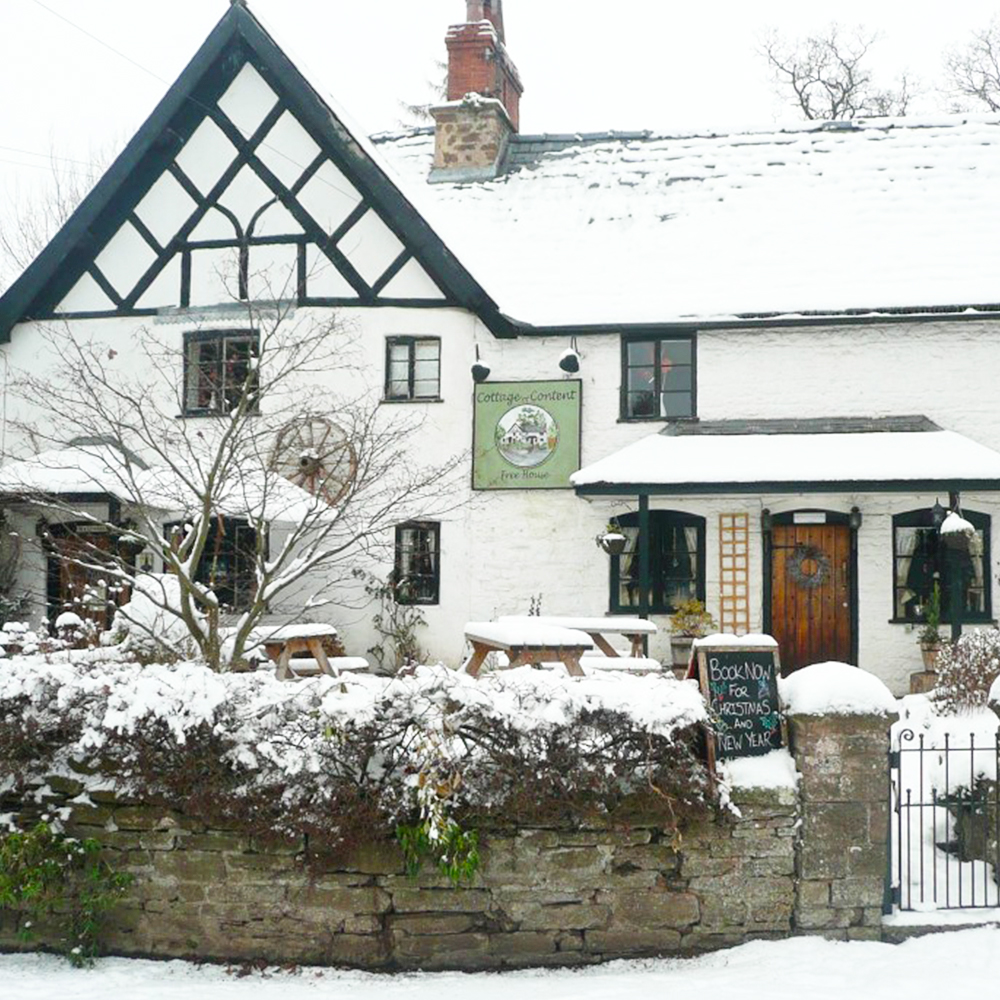 The Cottage of Content in the snow at Christmas